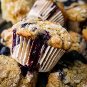 Stack of fluffy blueberry muffins on a pan.