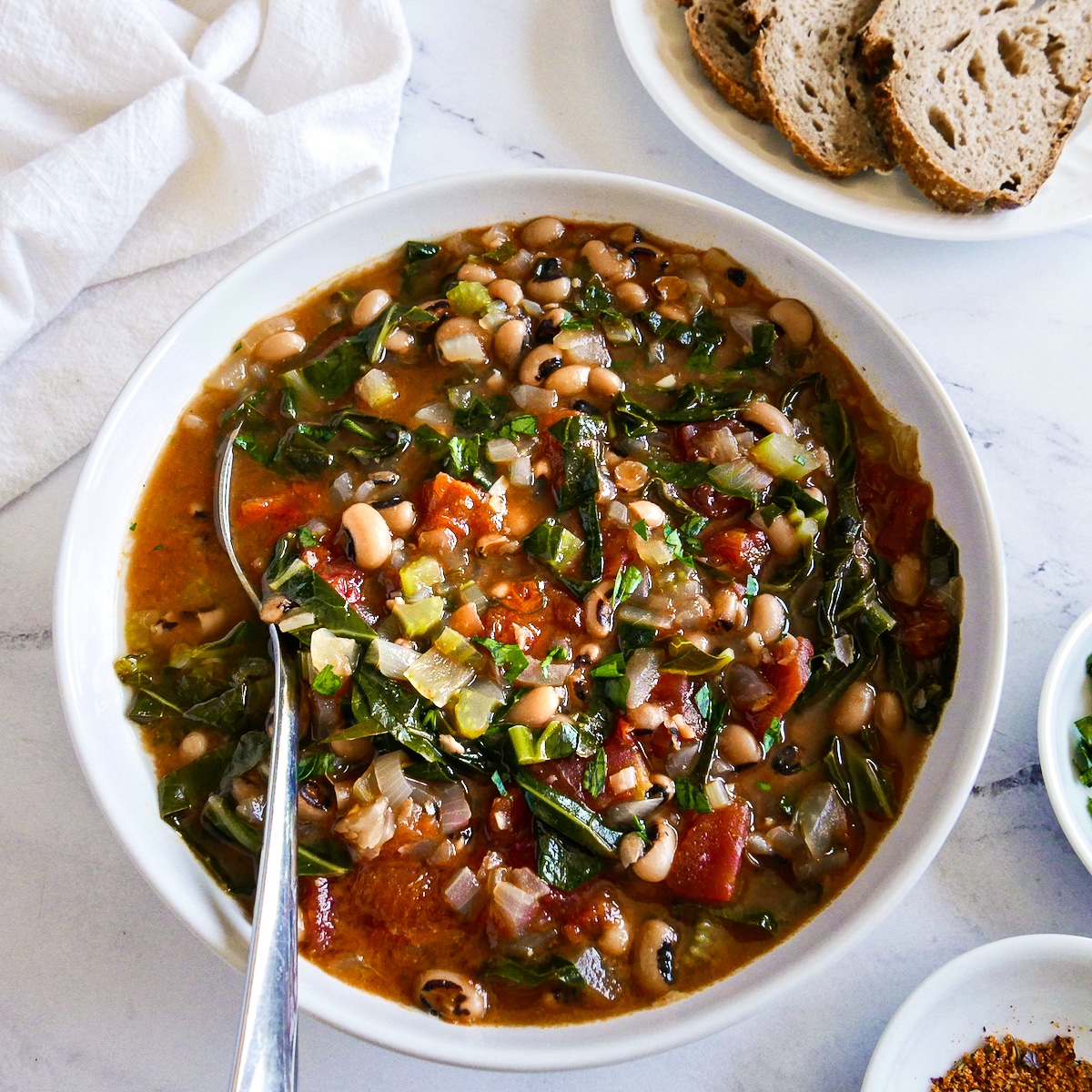 bowl-of-soup-on-napkin.jpg bowl of blacked eyed pea soup resting on a white napkin.