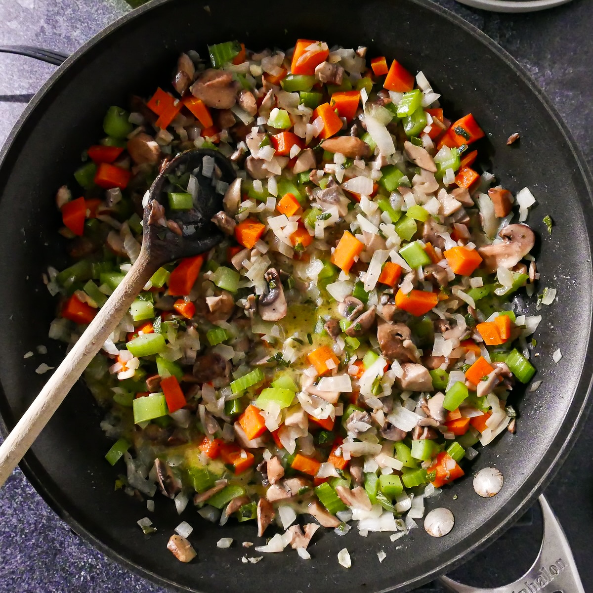 stuffing-mixture.jpg Mushrooms added to vegetable mixture in a skillet.