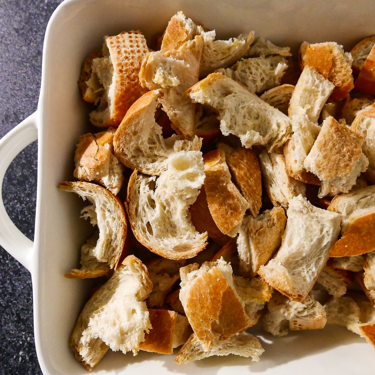 bread-in-dish.jpg Cut up bread placed in baking dish.
