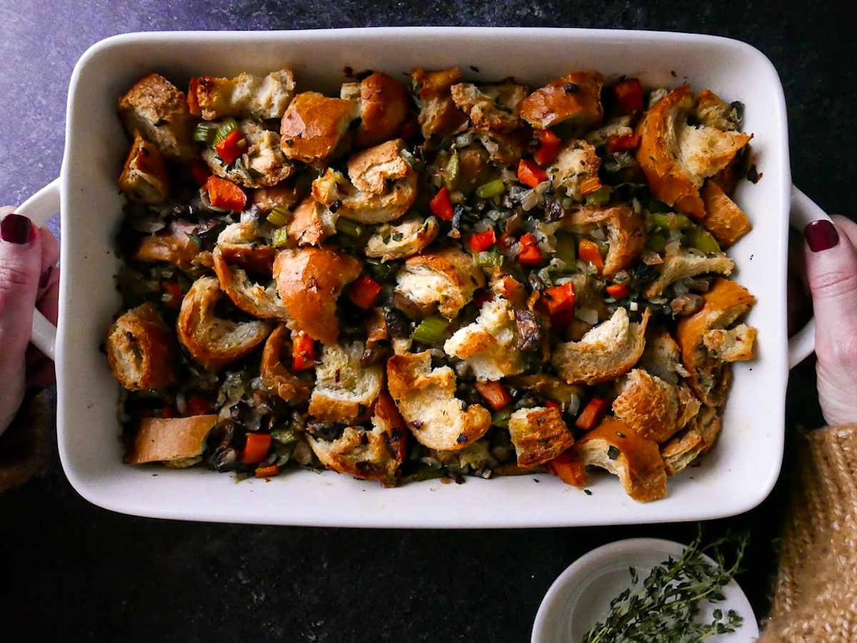 pan-of-stuffing.jpg Two hands holding a pan of vegetarian mushroom stuffing.