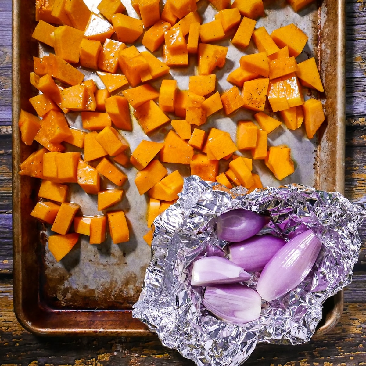 squash-and-shallots.jpg butternut squash cubes and shallots on a baking sheet.