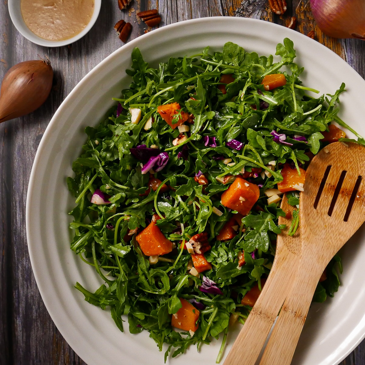 winter-squash-salad.jpg Winter squash salad with dressing and two serving spoons.