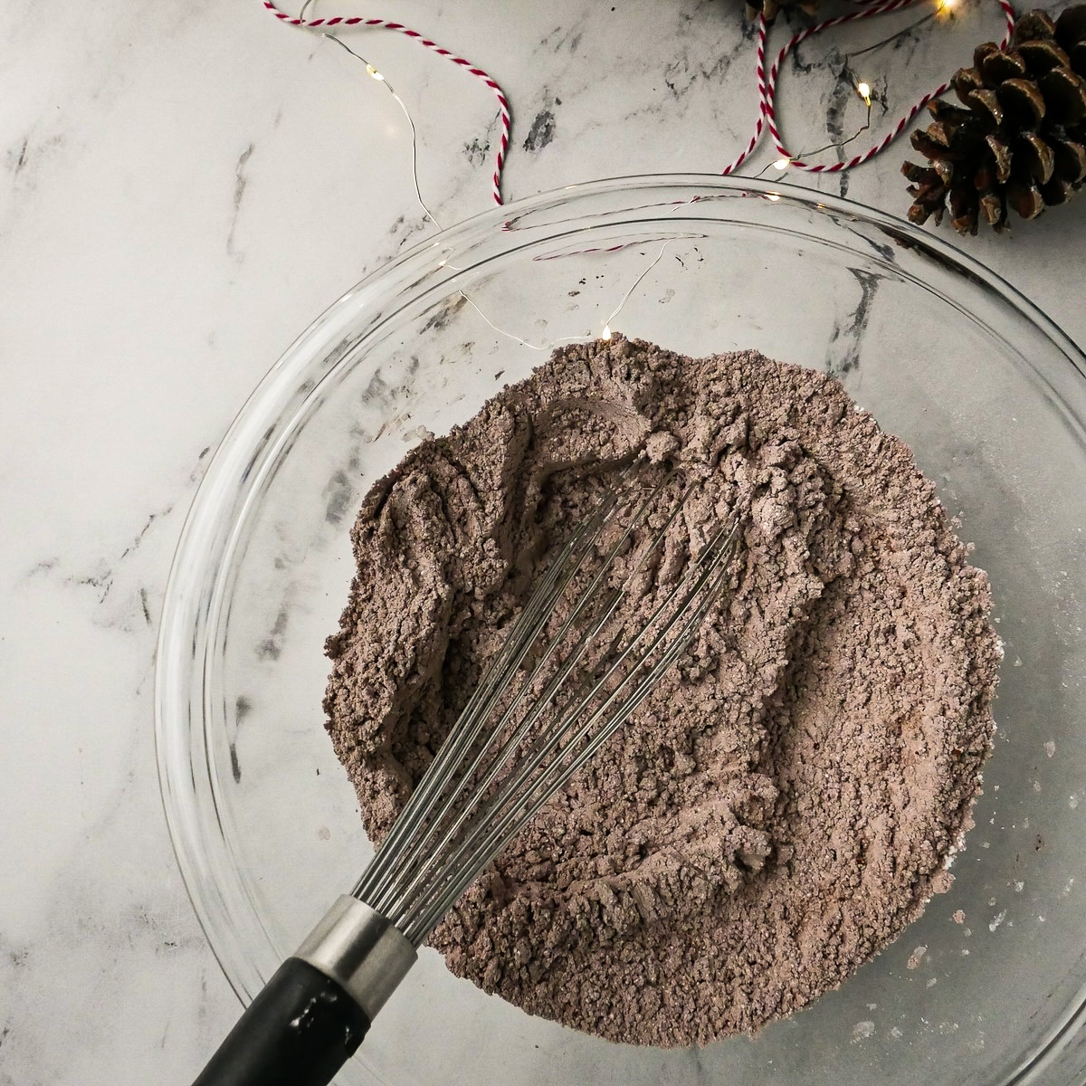 cocoa-powder-and-sugar.jpg Sifted powdered sugar and cocoa powder whisked together in a bowl.