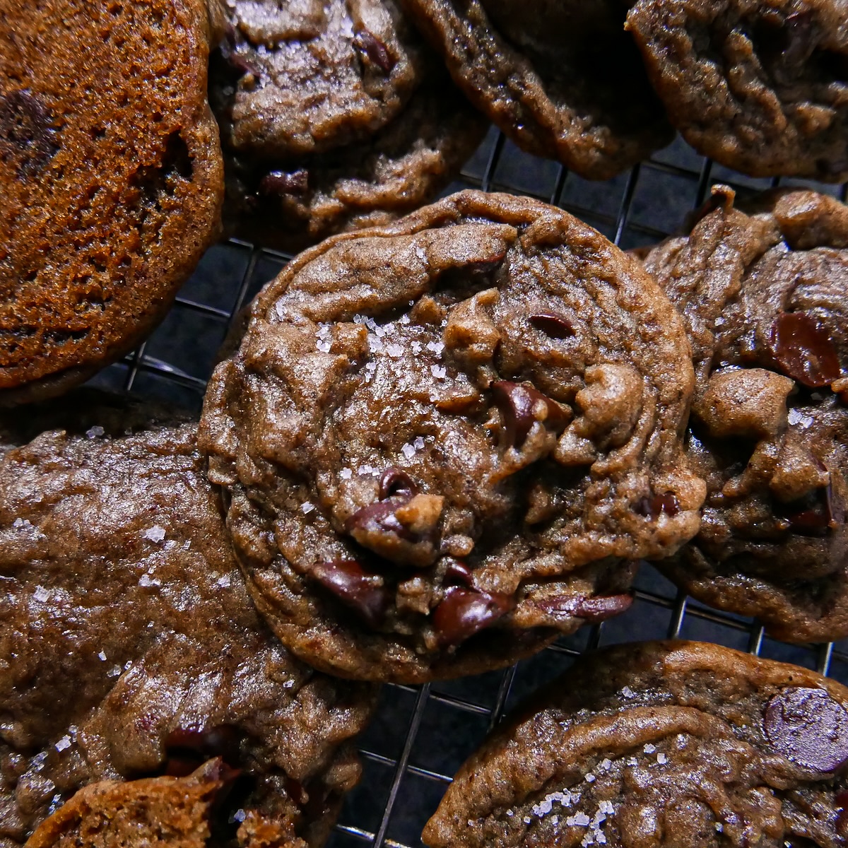 Gooey chocolate chip espresso cookies arranged on a wire rack.