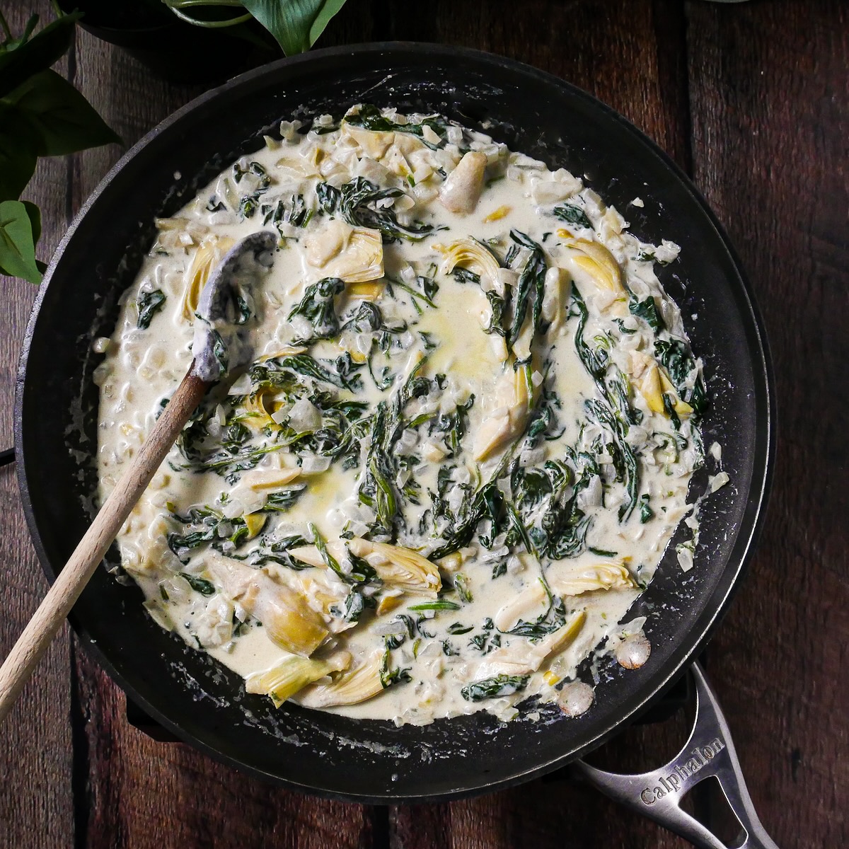 Artichoke hearts and grated Parmesan added to skillet.
