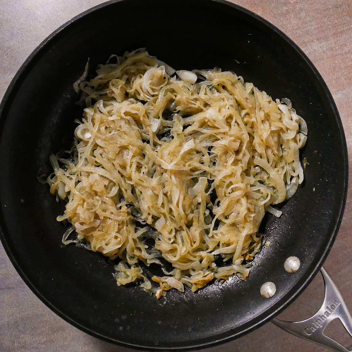 caramelizing-onions.jpg Caramelizing onions with butter in a large skillet.