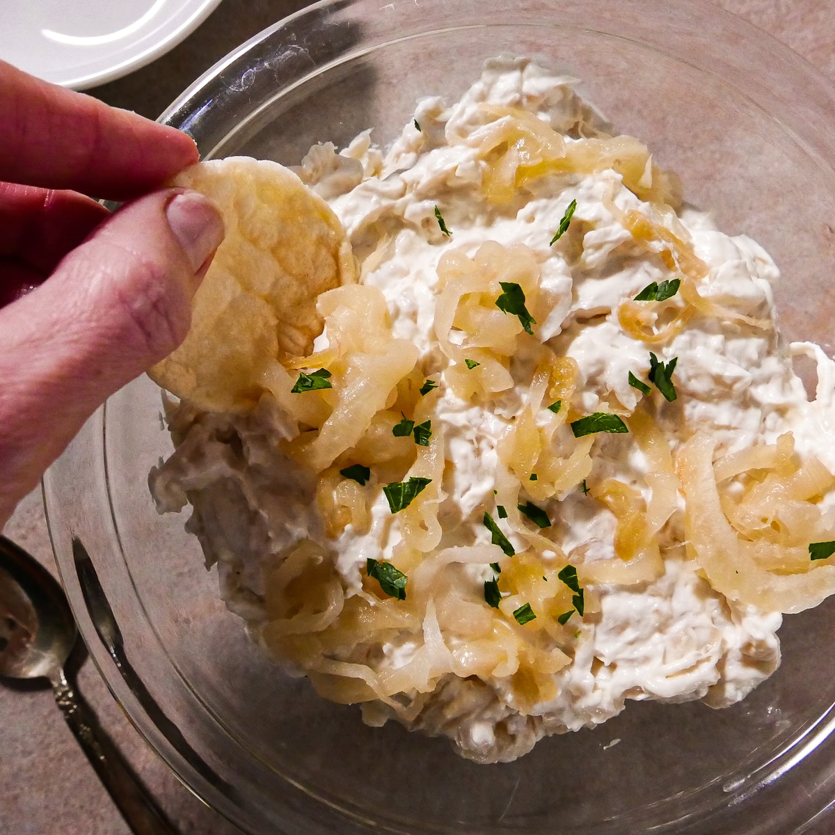 onion-dip.jpg Dipping a chip into a bowl of onion dip.
