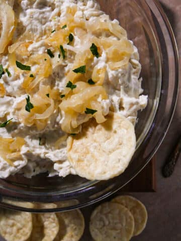 Homemade French onion dip in a bowl with chips.