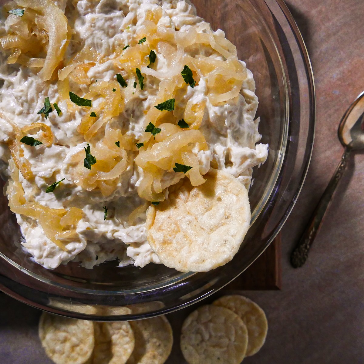 Homemade French onion dip in a bowl with chips.