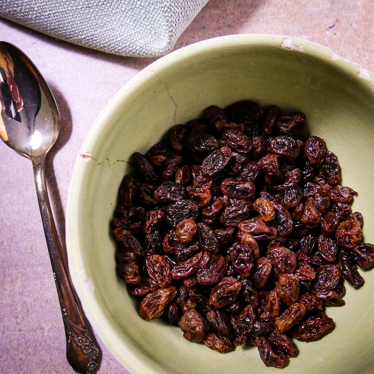 Softened raisins in a small bowl.