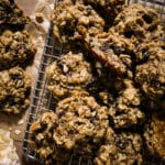 Homemade vegan cookies with oatmeal and raisin on a cooling rack.