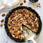 Sliced chocolate caramel pie with pie server.