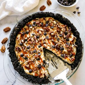 Sliced chocolate caramel pie with pie server.