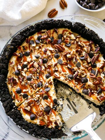 Sliced chocolate caramel pie with pie server.