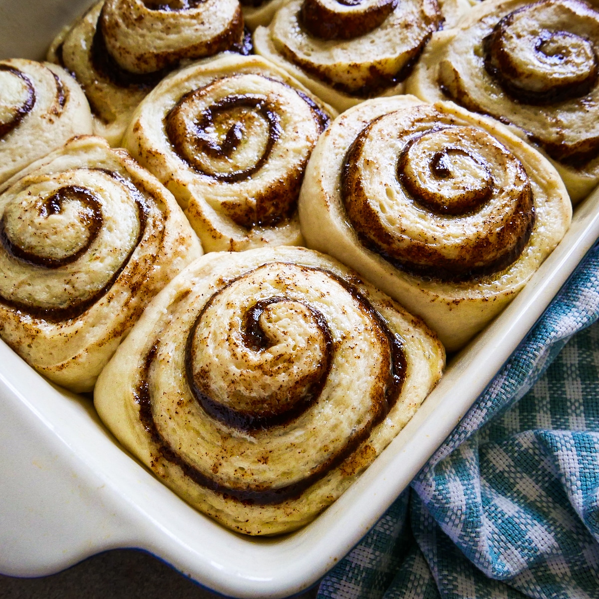 Cinnamon buns placed cut side up in a baking dish and doubled in size.
