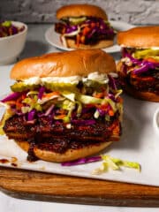 Crispy bbq tofu sandwich arranged on a cutting board.
