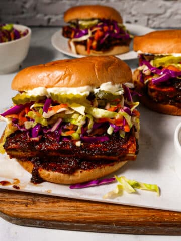 Crispy bbq tofu sandwich arranged on a cutting board.