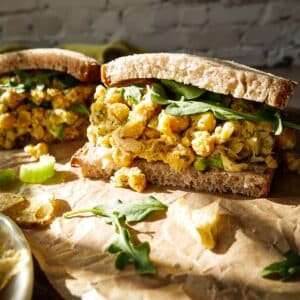 Chickpea salad sandwich arranged on a cutting board.