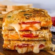 Cheesy garlic grilled cheese with tomato slices.