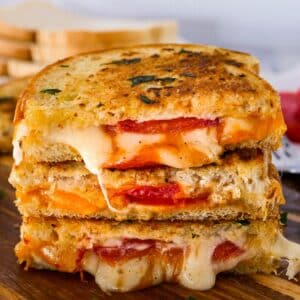Cheesy garlic grilled cheese with tomato slices.