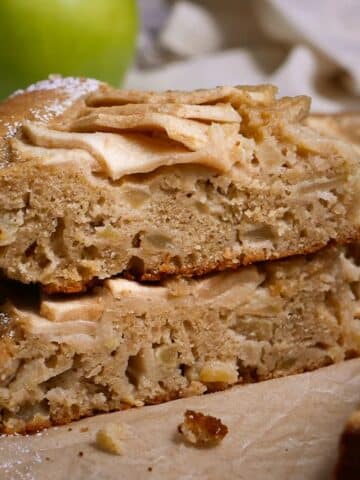 moist apple cake stacked on a plate.