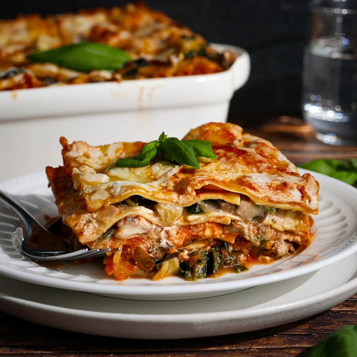 Slice of veggie lasagna on a plate.