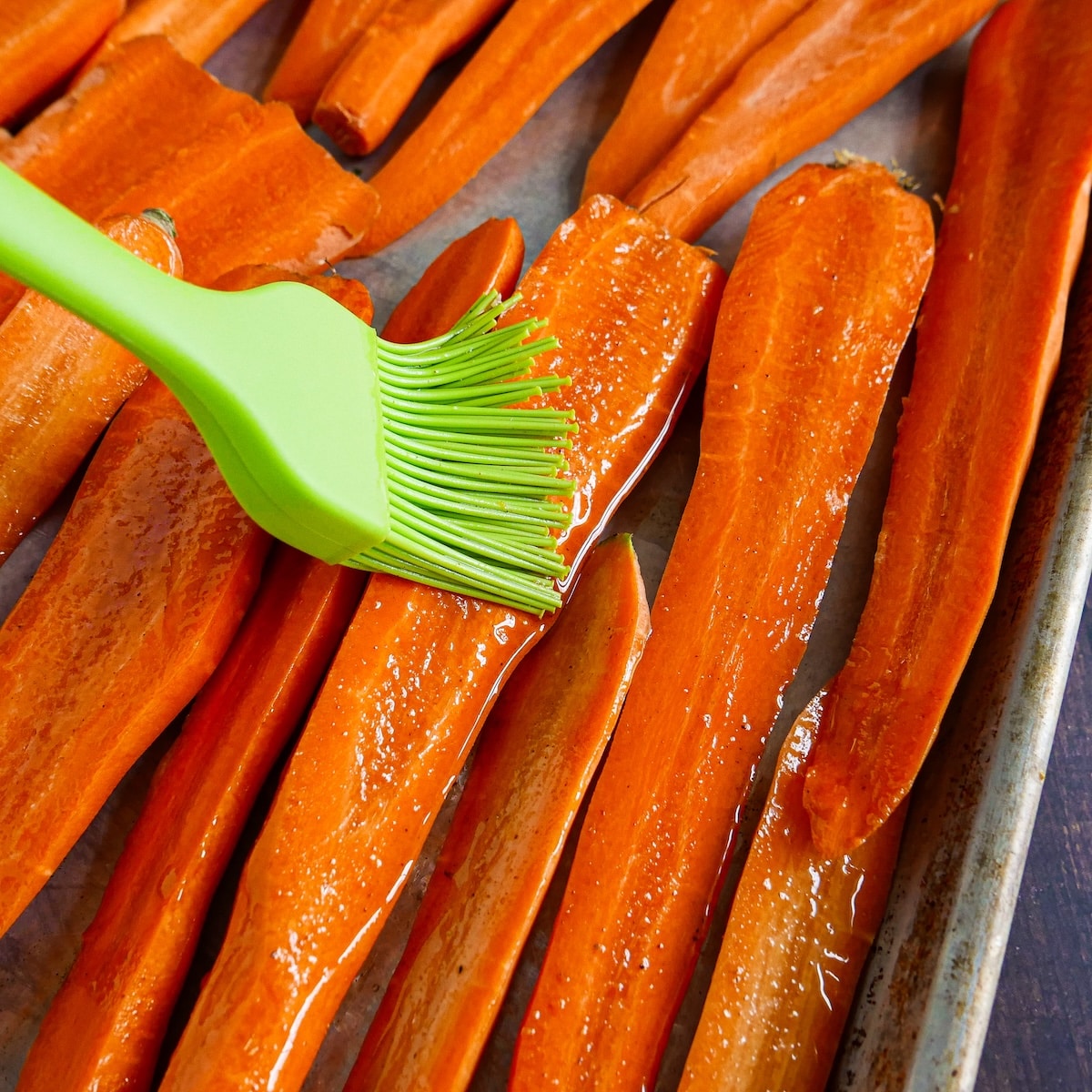 brushing-glaze-on-carrots.jpg Brushing maple-cumin glaze on halved carrots.