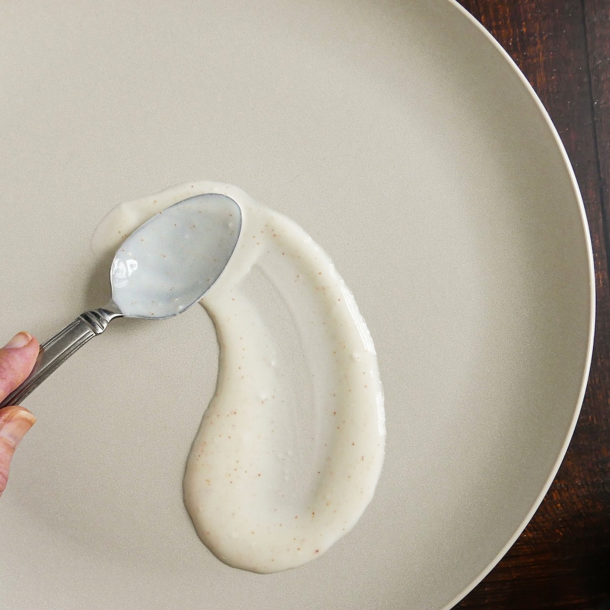 swooshing-yogurt-sauce.jpg Using a spoon to swoosh yogurt sauce on a platter.