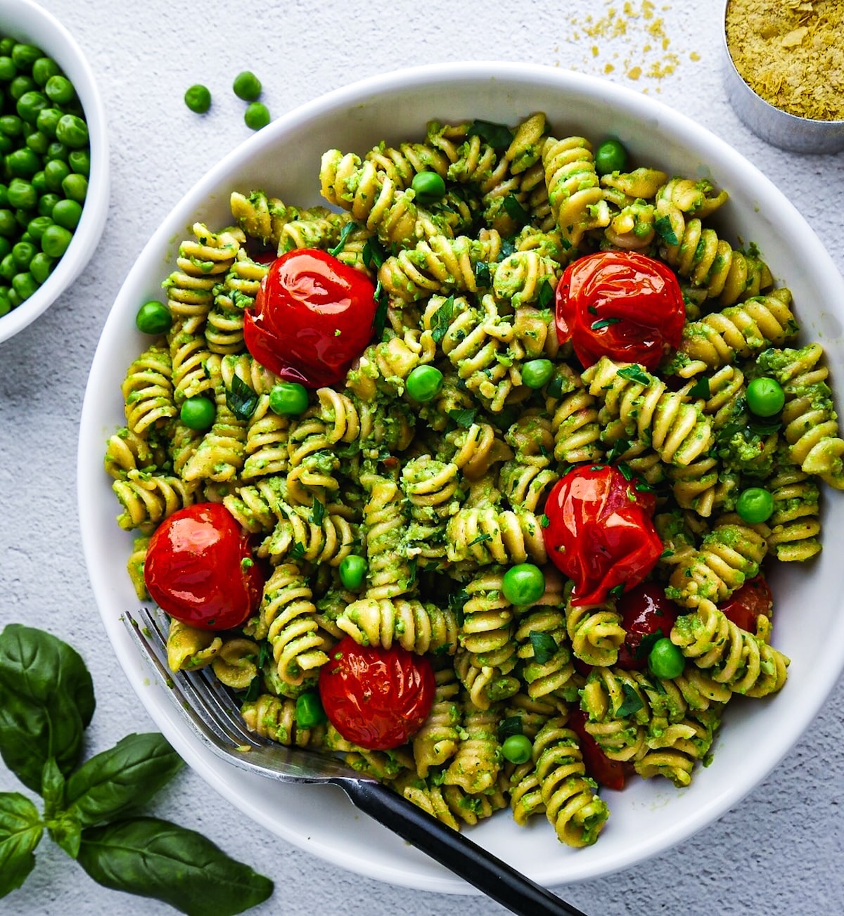Creamy pesto pasta with peas and roasted tomatoes.
