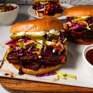 Crispy bbq tofu sandwich arranged on a cutting board.