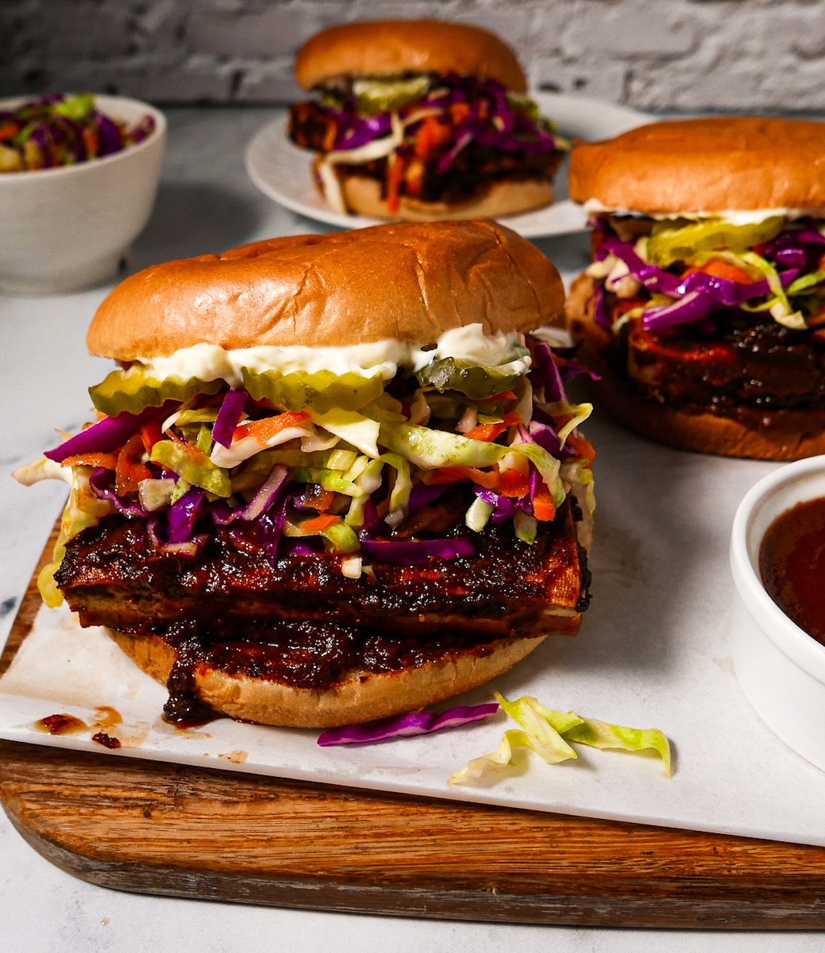 Crispy bbq tofu sandwich arranged on a cutting board. 