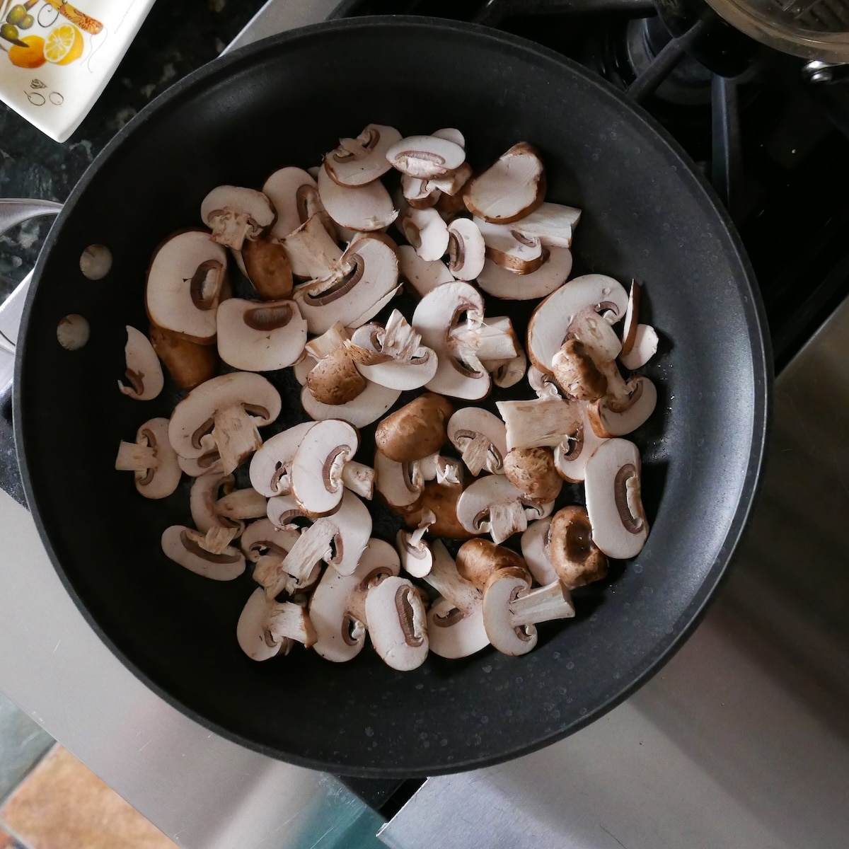 sauteeing-mushrooms.jpg Sauteeing mushrooms in a large skillet.