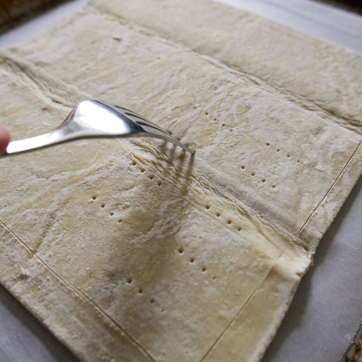 scoring-puff-pastry.jpg Scoring thawed puff pastry and poking holes with a fork.