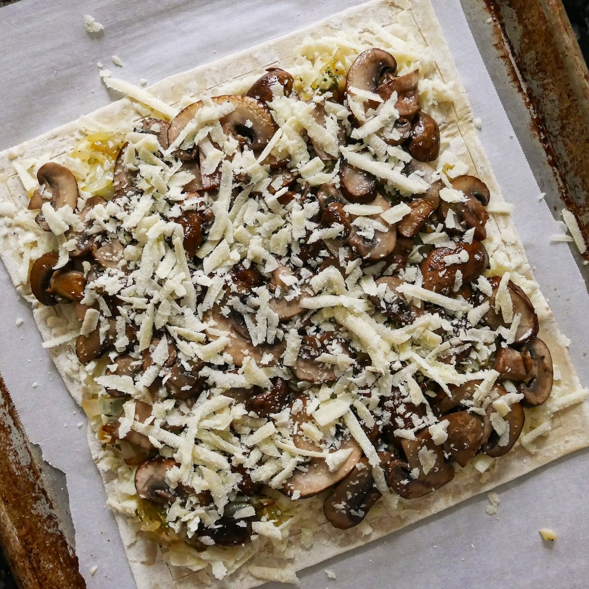 tart-topped-with-cheese.jpg Finishing easy tart with grated Parmesan cheese.