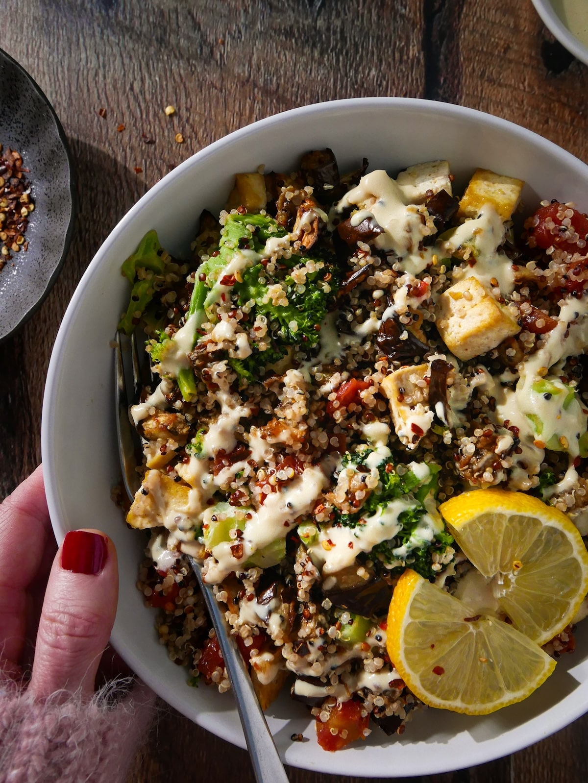 quioa-bowl-with-vegetables.jpg Quinoa bowl with vegetables and drizzled with tahini sauce.