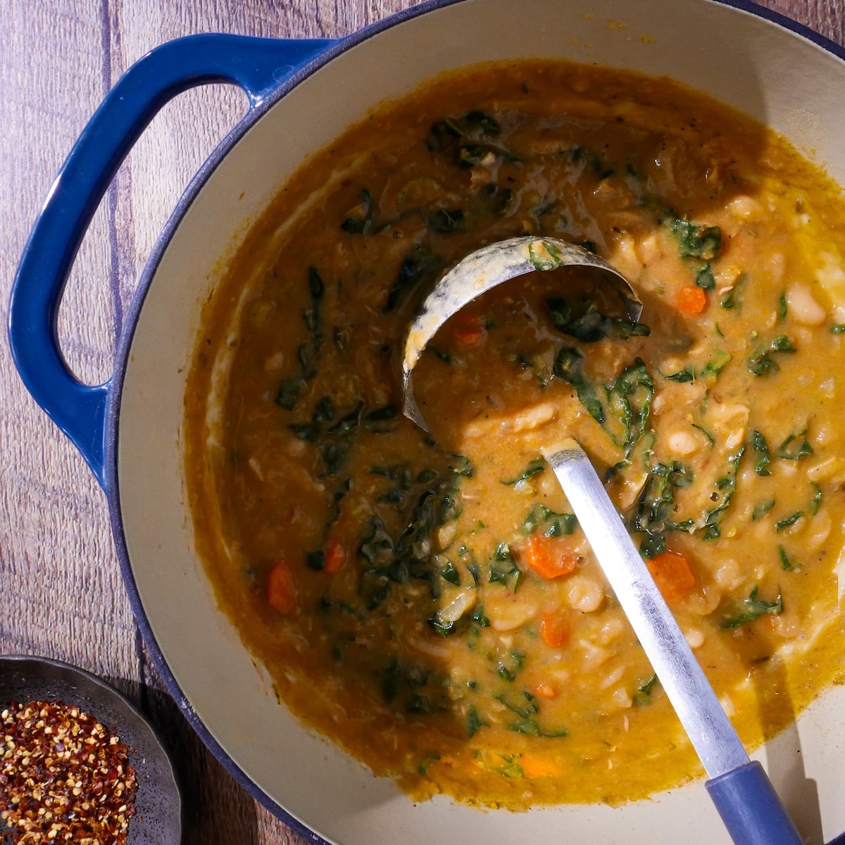 blended-soup.jpg Blended soup in pot with cooked kale leaves.