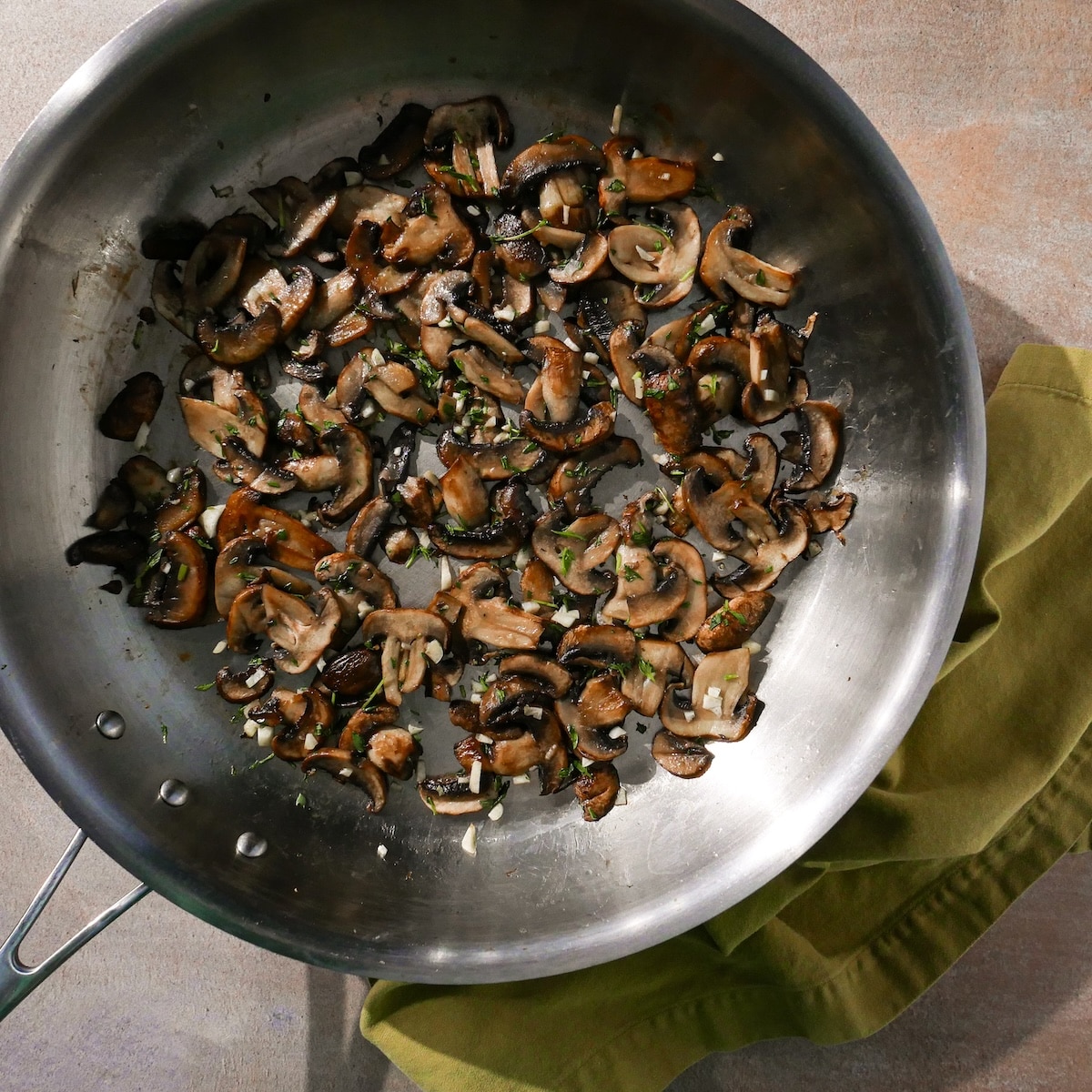 garlic-thyme-and-mushrooms.jpg Adding garlic and thyme to cooked mushrooms.