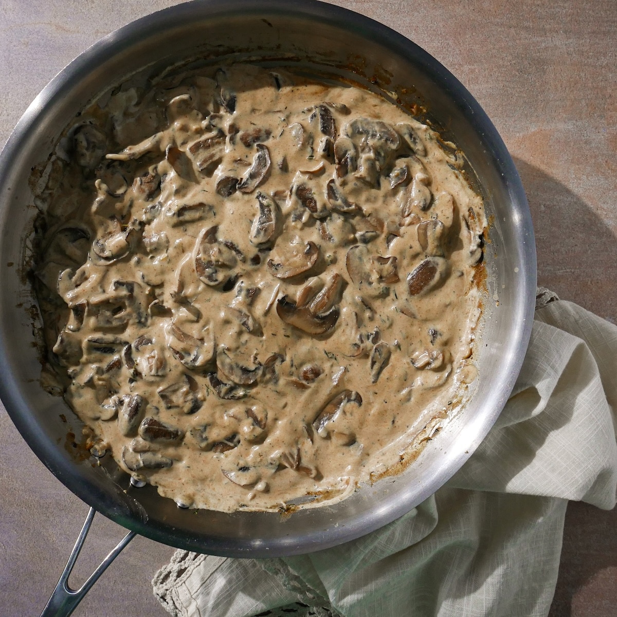 sour-cream-in-stroganoff.jpg Mustard and sour cream stirred into mushroom stroganoff off heat.