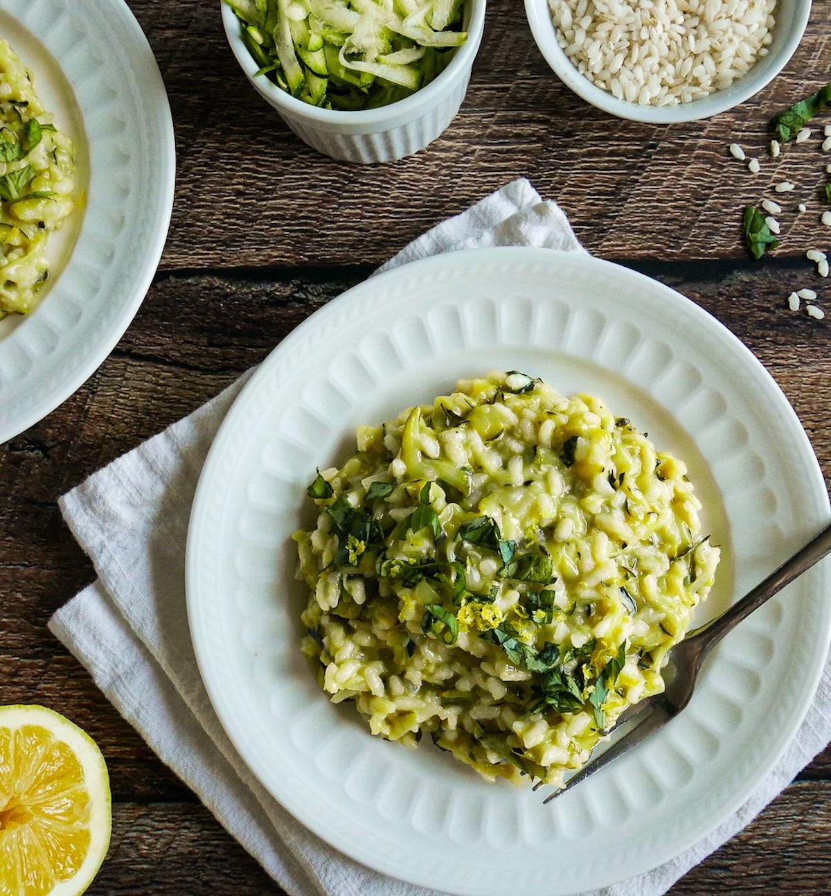 summer-squash-risotto.jpg Summer squash risotto arranged on a white plate with a fork.