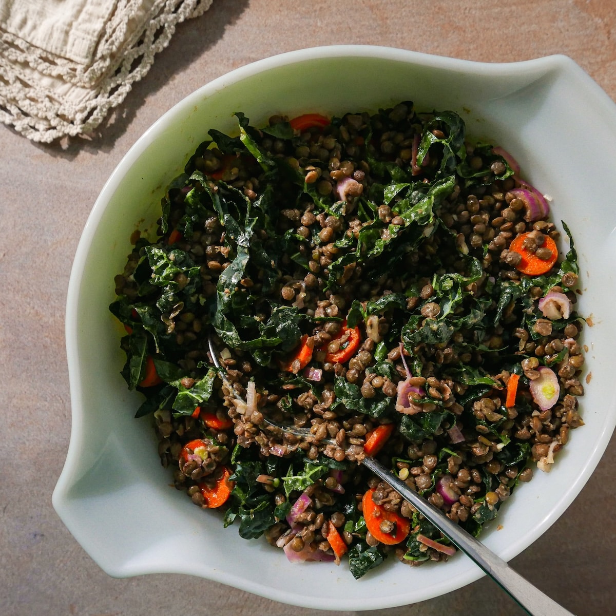 lentil-salad.jpg Cooked lentils mixed with kale, carrots, dressing, and seasoning.