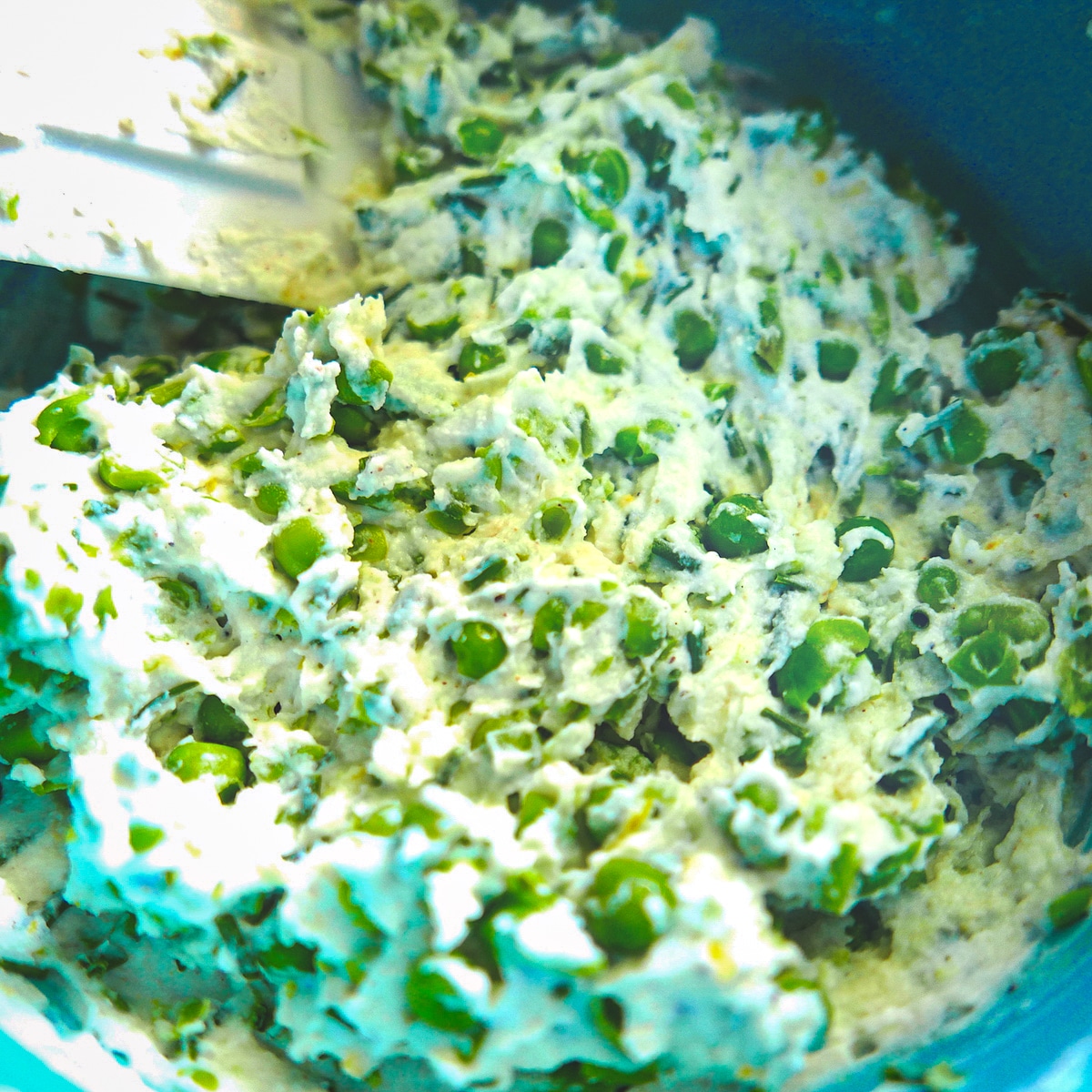 pea-ricotta-filling.jpg pea ricotta filling being mixed in a bowl.