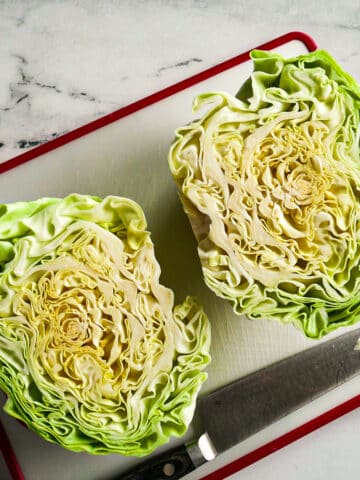 Sliced green cabbage resting on a cutting board.