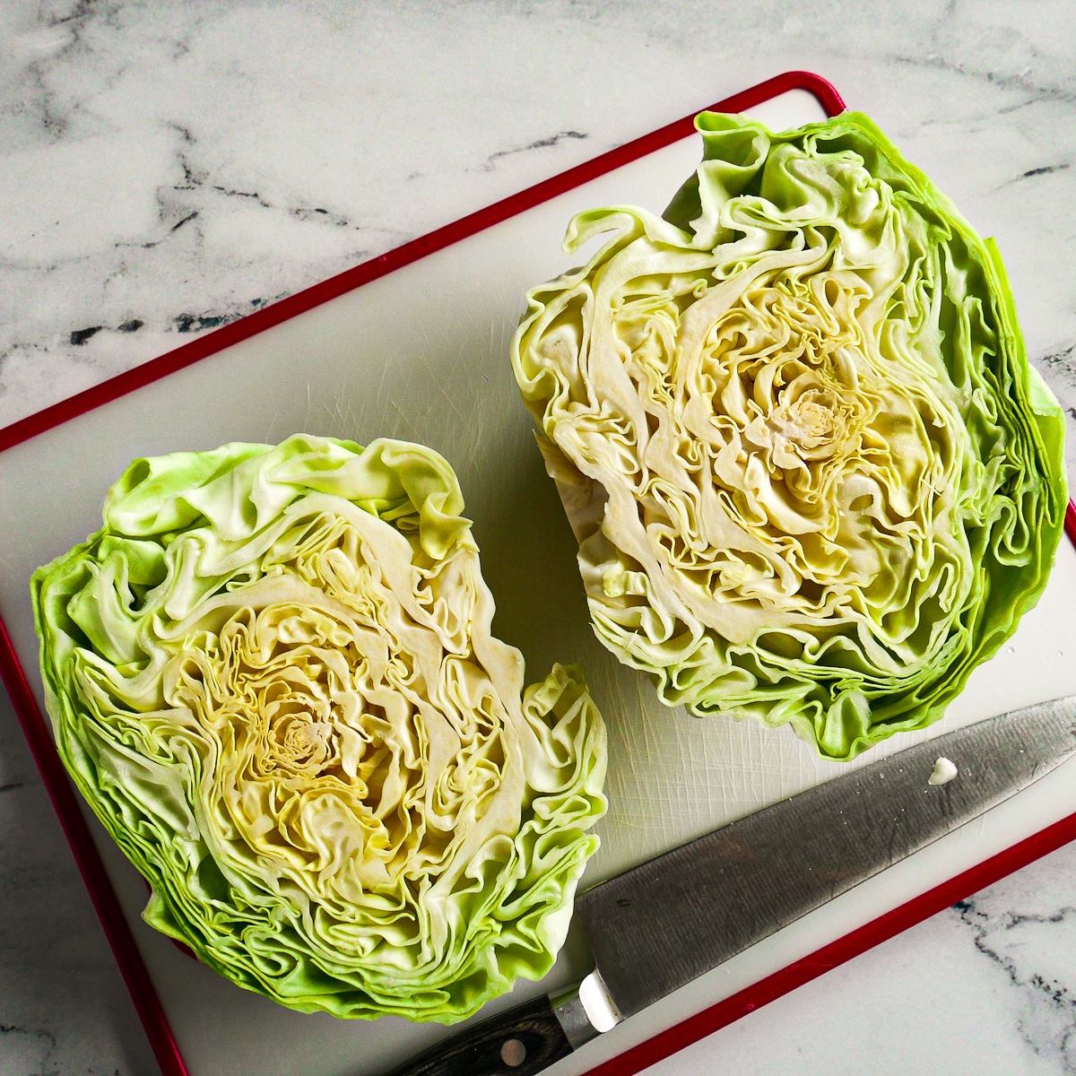 Sliced green cabbage resting on a cutting board.