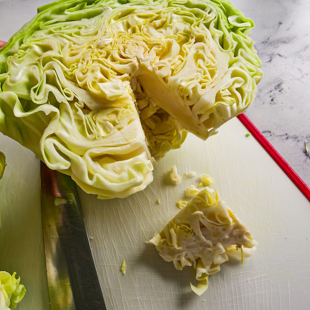 coring-cabbage.jpg Half of cabbage with core cut out of it.