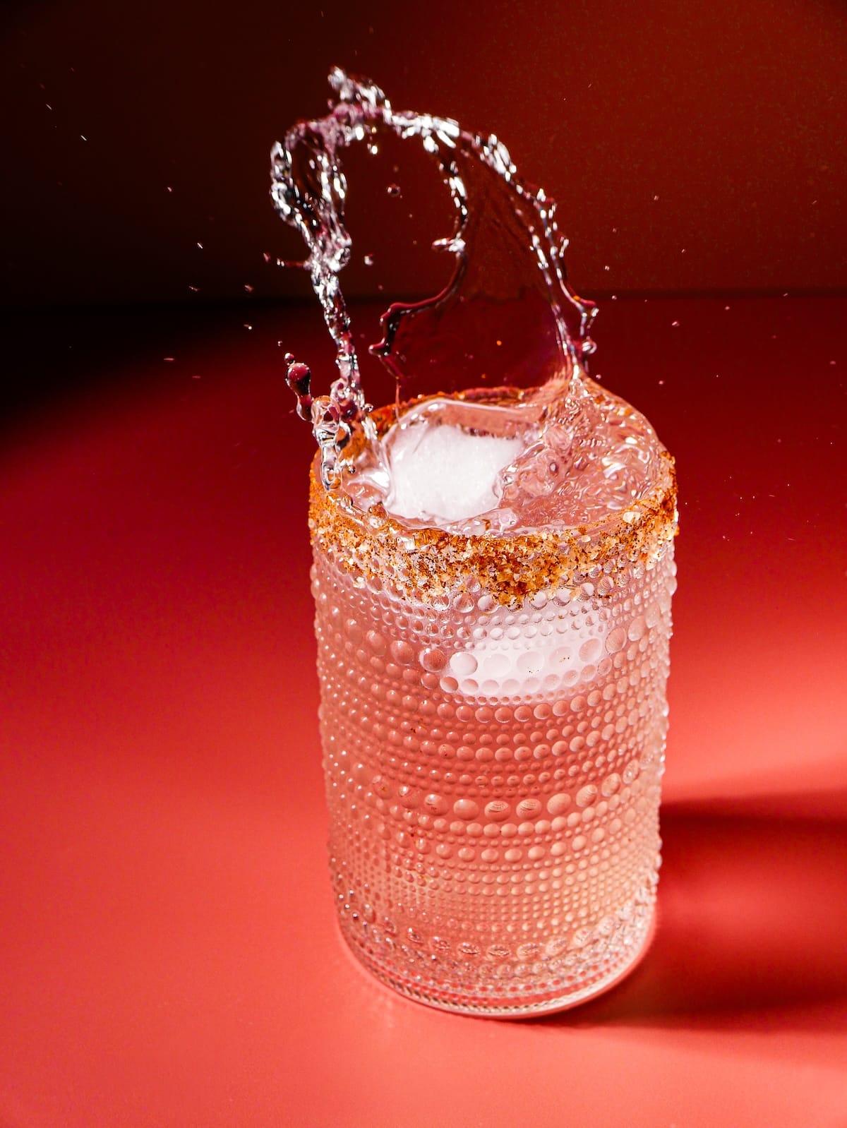 glass-of-water.jpg ice cube splashing in glass of water.