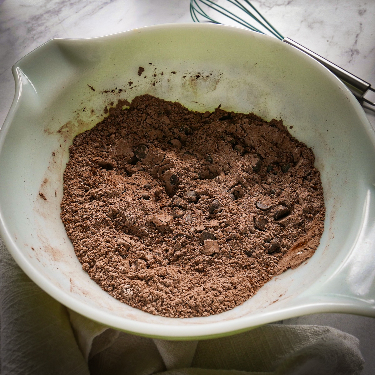 dry-ingredients-in-a-bowl.jpg Flour, cocoa powder, baking soda, cinnamon, salt, and chocolate chips mixed in a bowl.