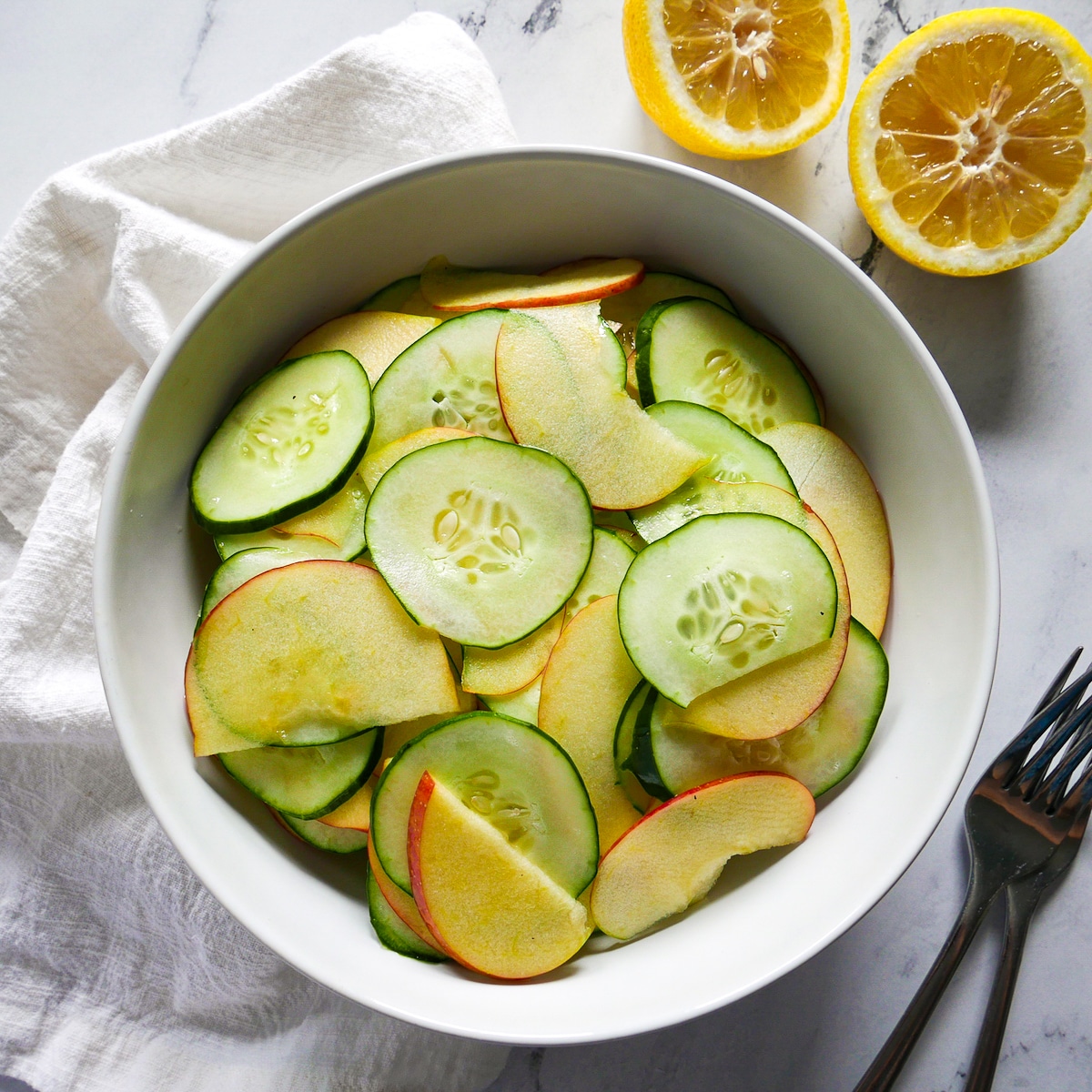 summer-salad.jpg Summer salad with cucumbers and apples in a bowl.