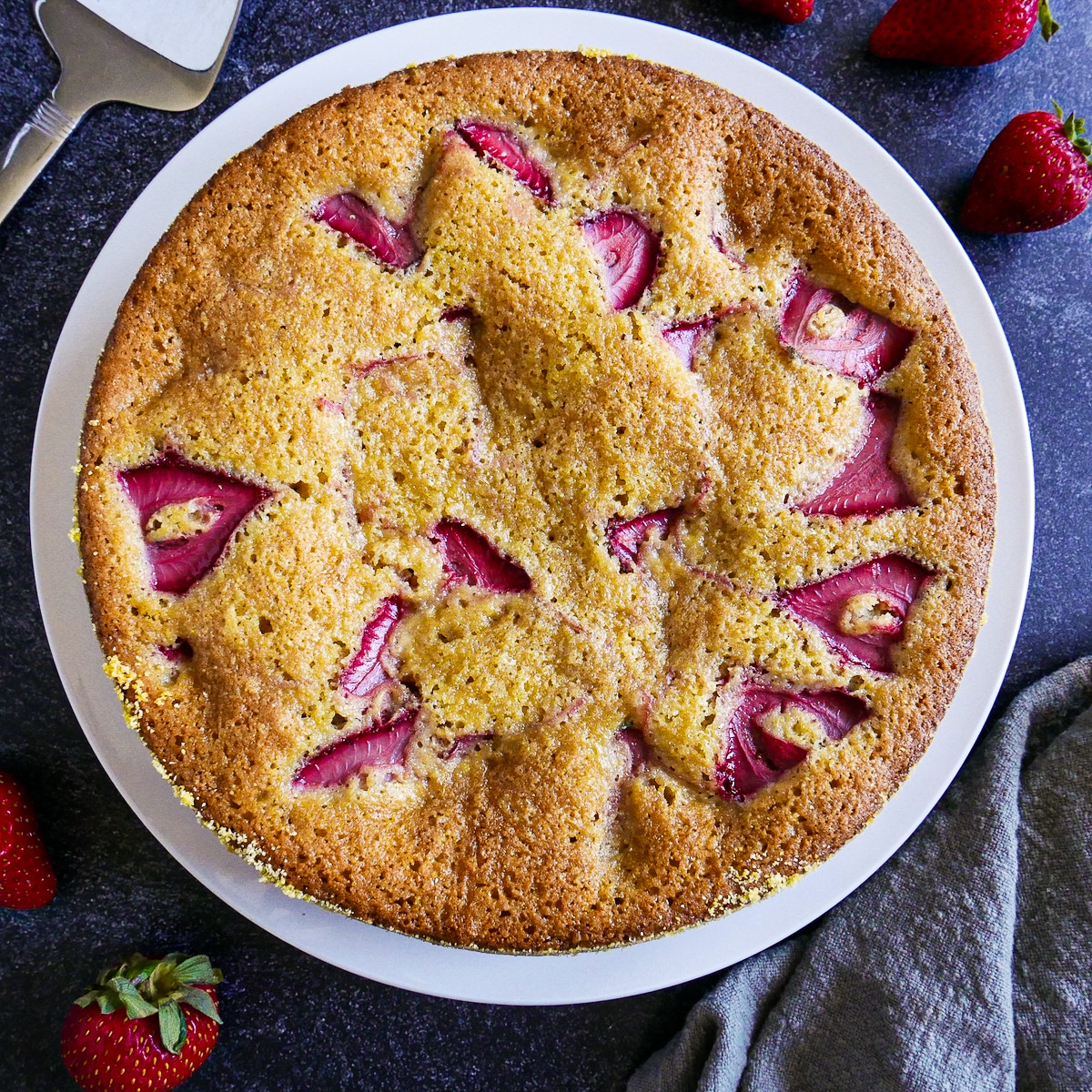 baked-strawberry-cake.jpg Baked strawberry cake resting on a cooling rack.