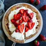 Strawberry vanilla cake with fresh strawberries and whipped cream.